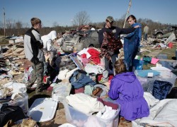 Families pick up pieces of homes swept away by tornadoes in Kentucky